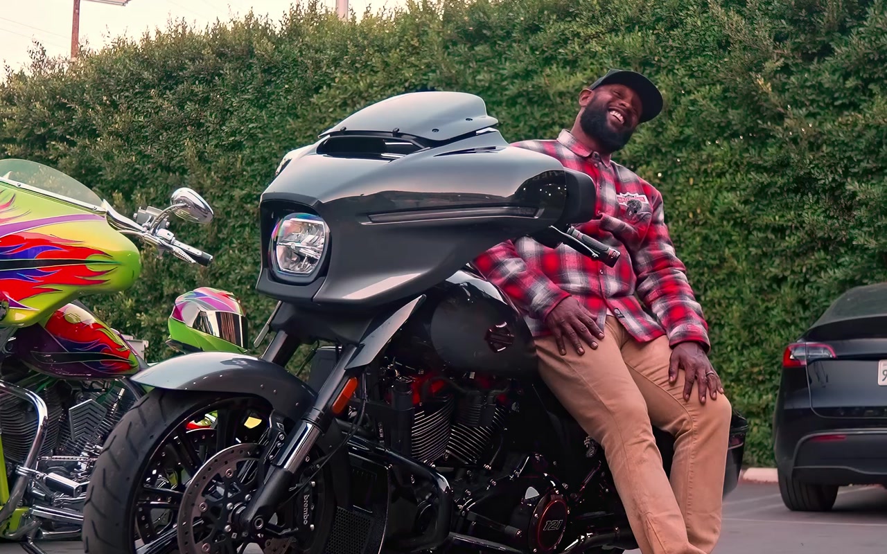 Stevan Ridley alongside a Harley-Davidson motorcycle outside Bike Shed