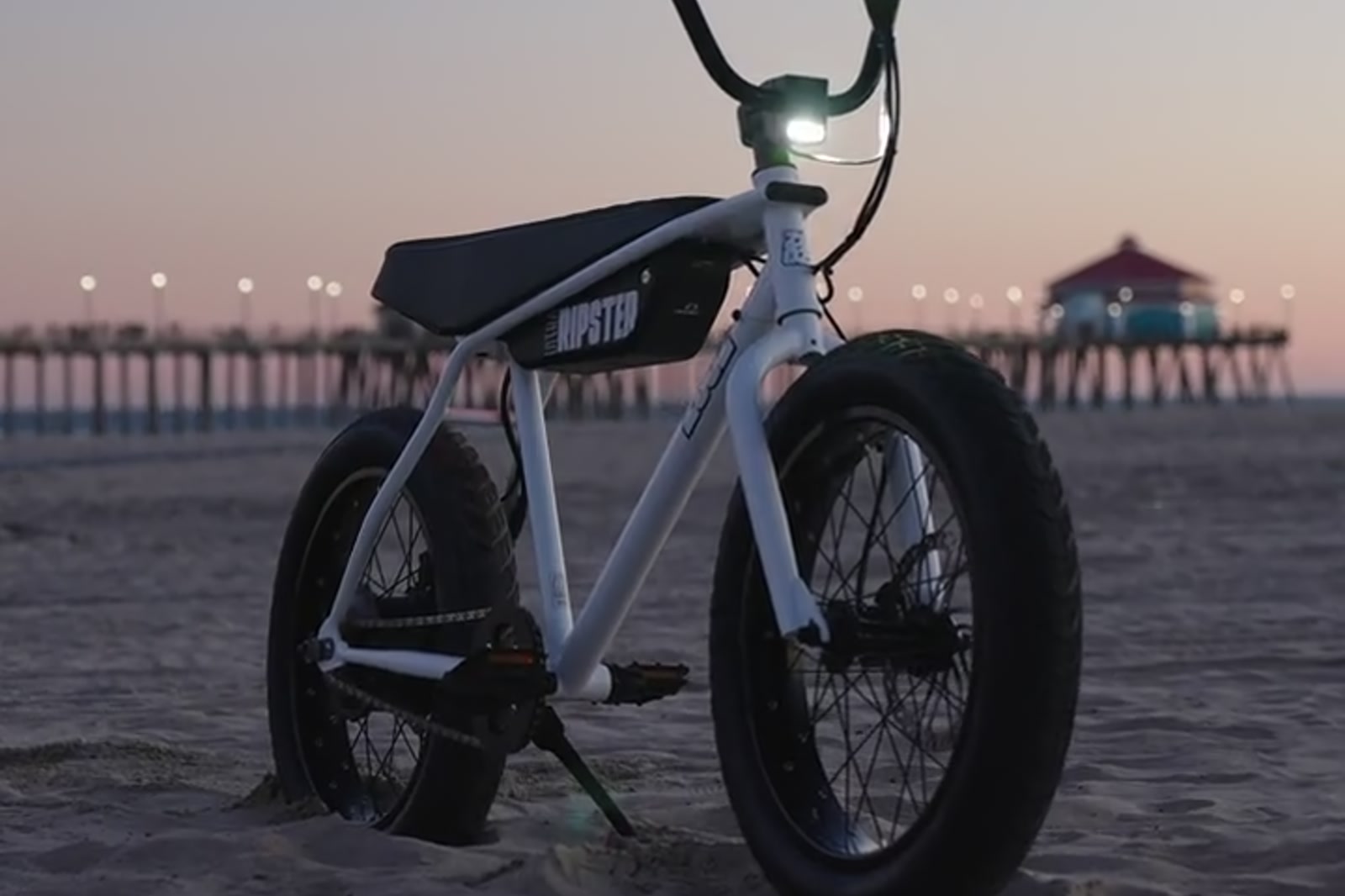 Zooz electric bicycle by the beach at sunset