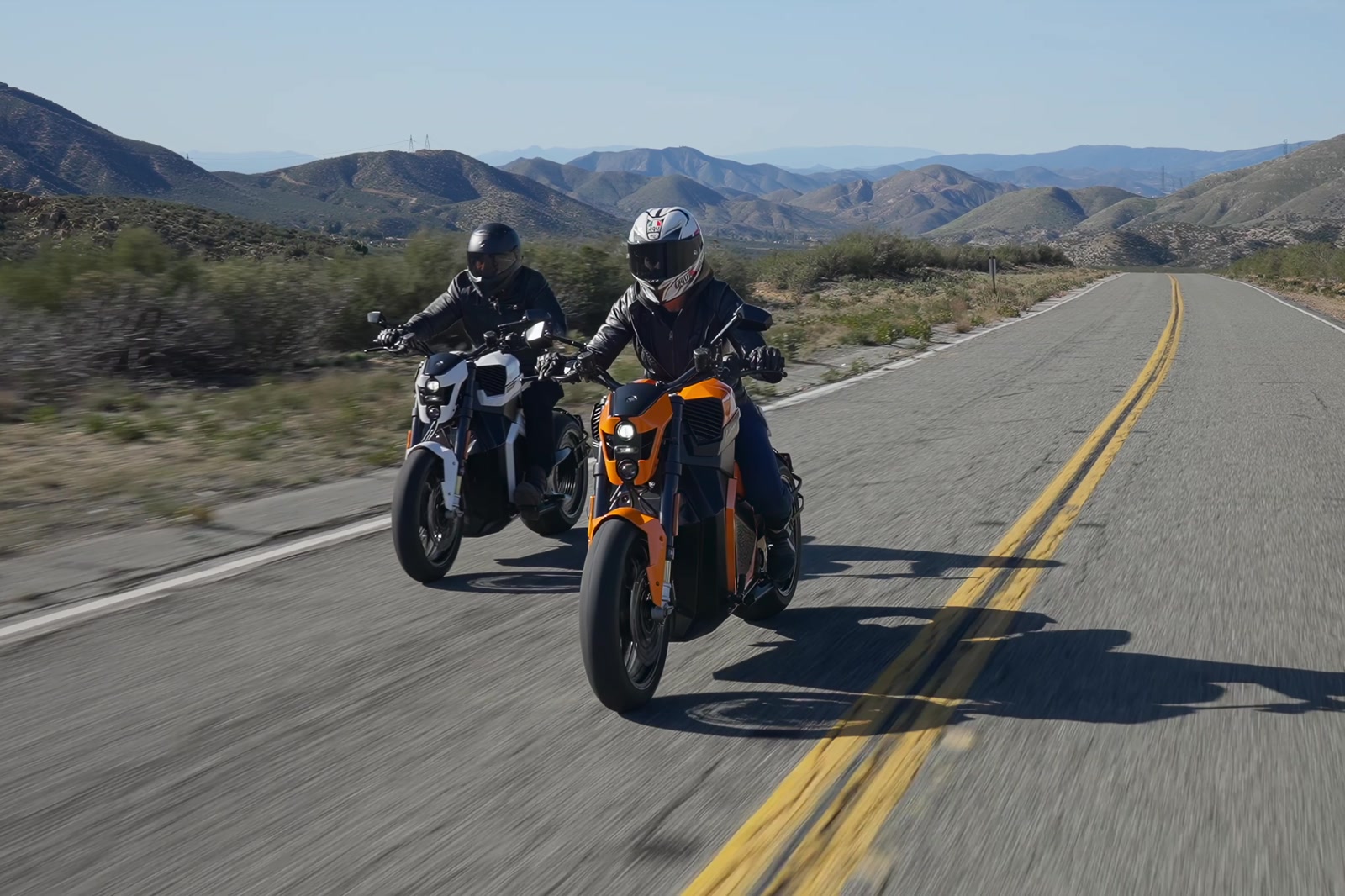 Two Verge motorcycles riding a winding mountain road